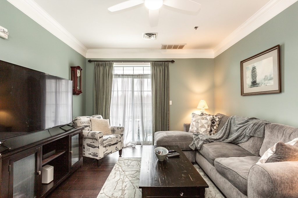1481 Phillips Road, Unit 1305 New Bedford, MA 02745 - Photo 10 of 34 a living room with furniture and a flat screen tv
