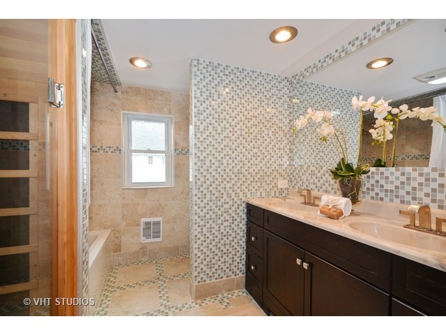 306 Spring Avenue Naperville, IL 60540 - Photo 14 of 25 a bathroom with a sink mirror and a shower