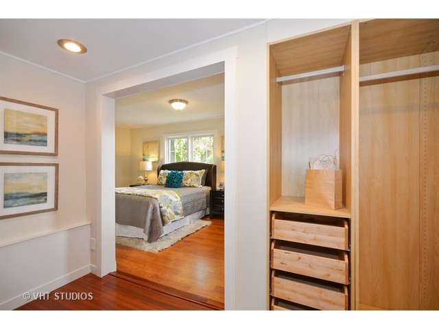 306 Spring Avenue Naperville, IL 60540 - Photo 16 of 25 a view of a bedroom with wooden floor and windows