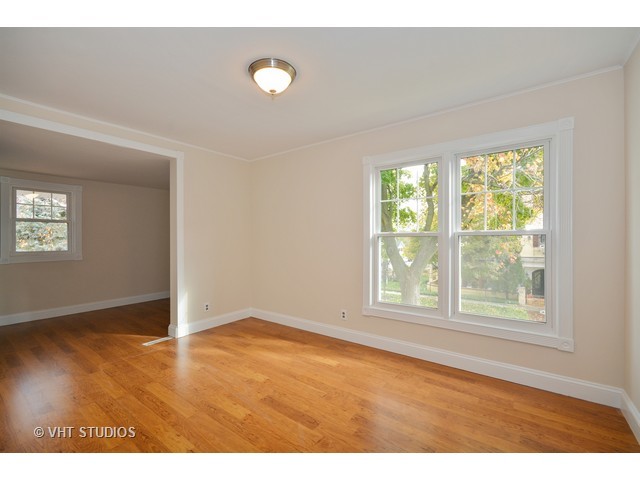 306 Spring Avenue Naperville, IL 60540 - Photo 19 of 25 a view of an empty room with wooden floor and a window
