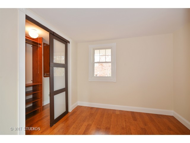 306 Spring Avenue Naperville, IL 60540 - Photo 20 of 25 a view of empty room with wooden floor and fan