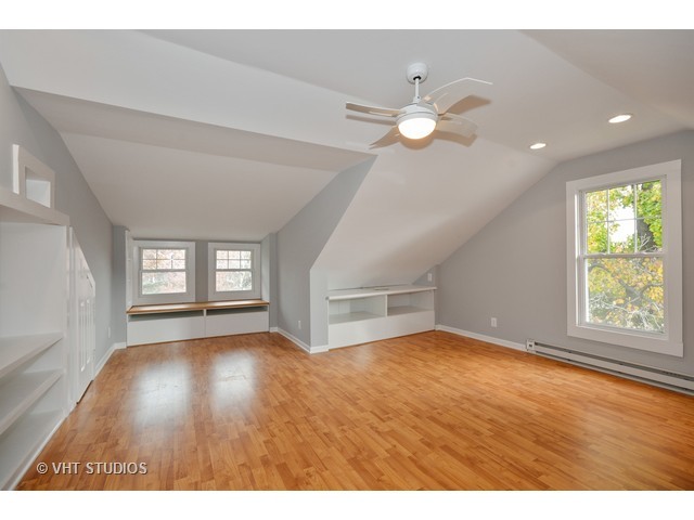 306 Spring Avenue Naperville, IL 60540 - Photo 22 of 25 a view of an empty room with window and wooden floor