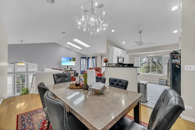 a view of a dining room with furniture and a chandelier