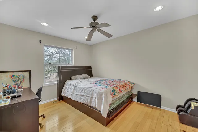 a bedroom with a bed and ceiling fan