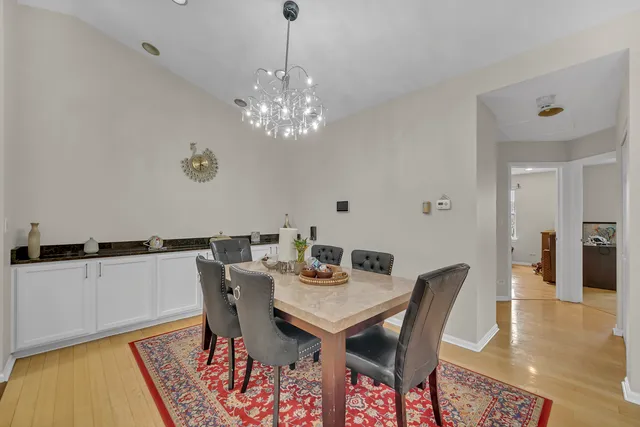 a view of a dining room with furniture wooden floor and chandelier