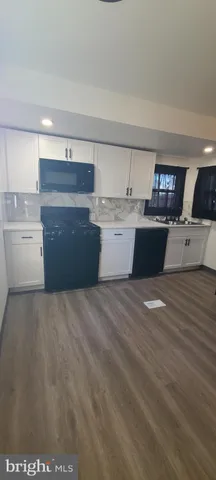 a room with a lot of cabinets and wooden floor