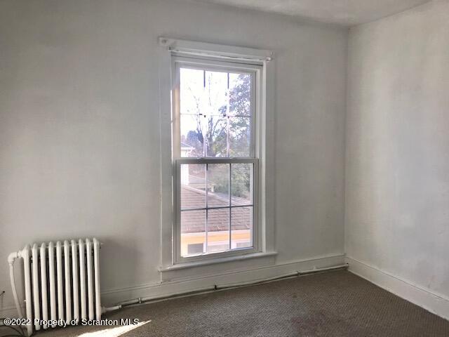 214 Main Street Moosic, PA 18507 - Photo 13 of 19 an empty room with wooden floor and windows