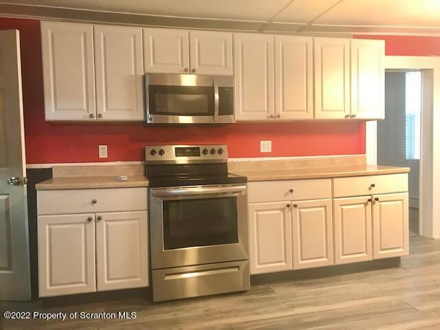214 Main Street Moosic, PA 18507 - Photo 2 of 19 a kitchen with stainless steel appliances granite countertop white cabinets and a stove