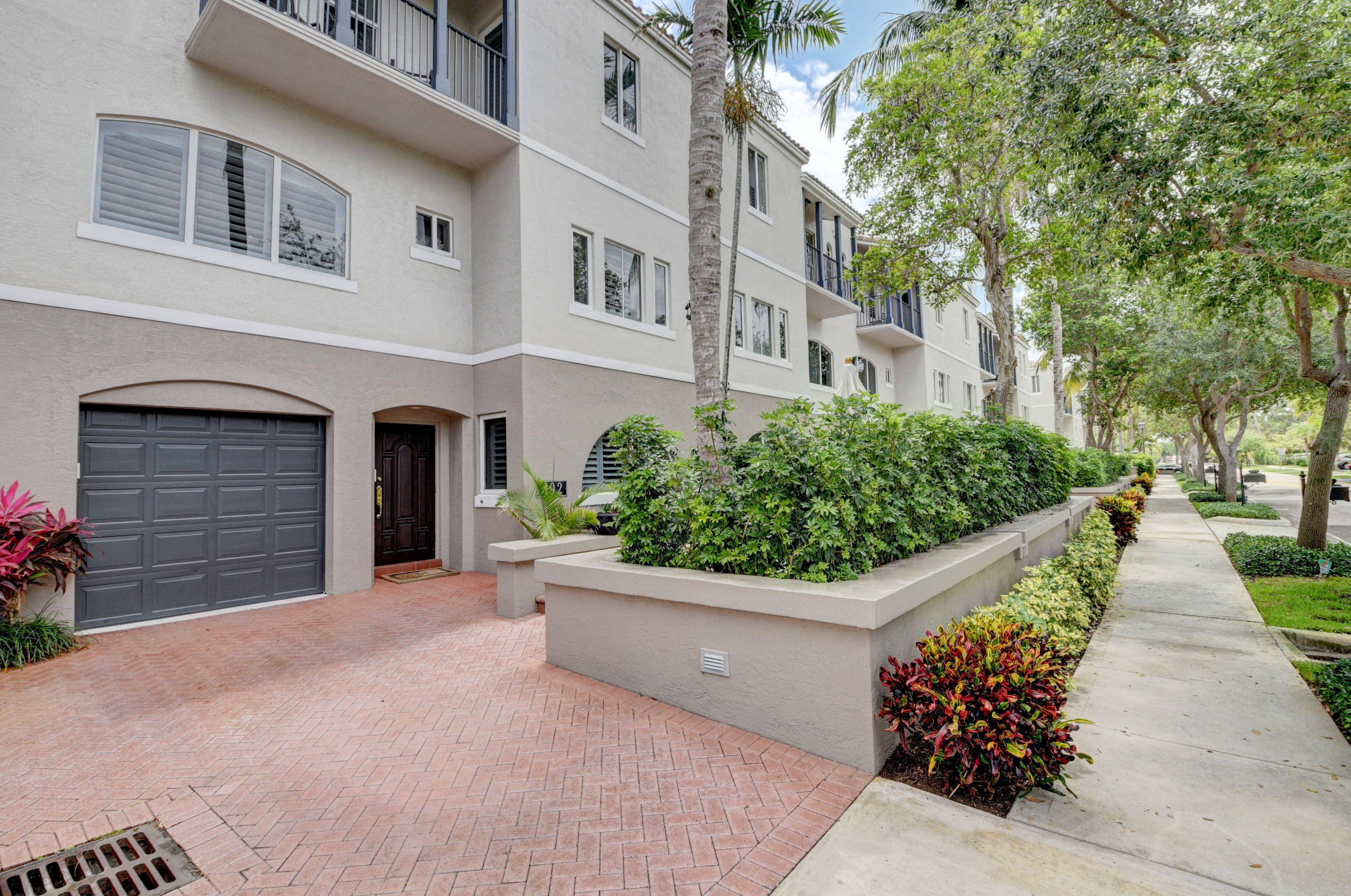 a view of a house with potted plants