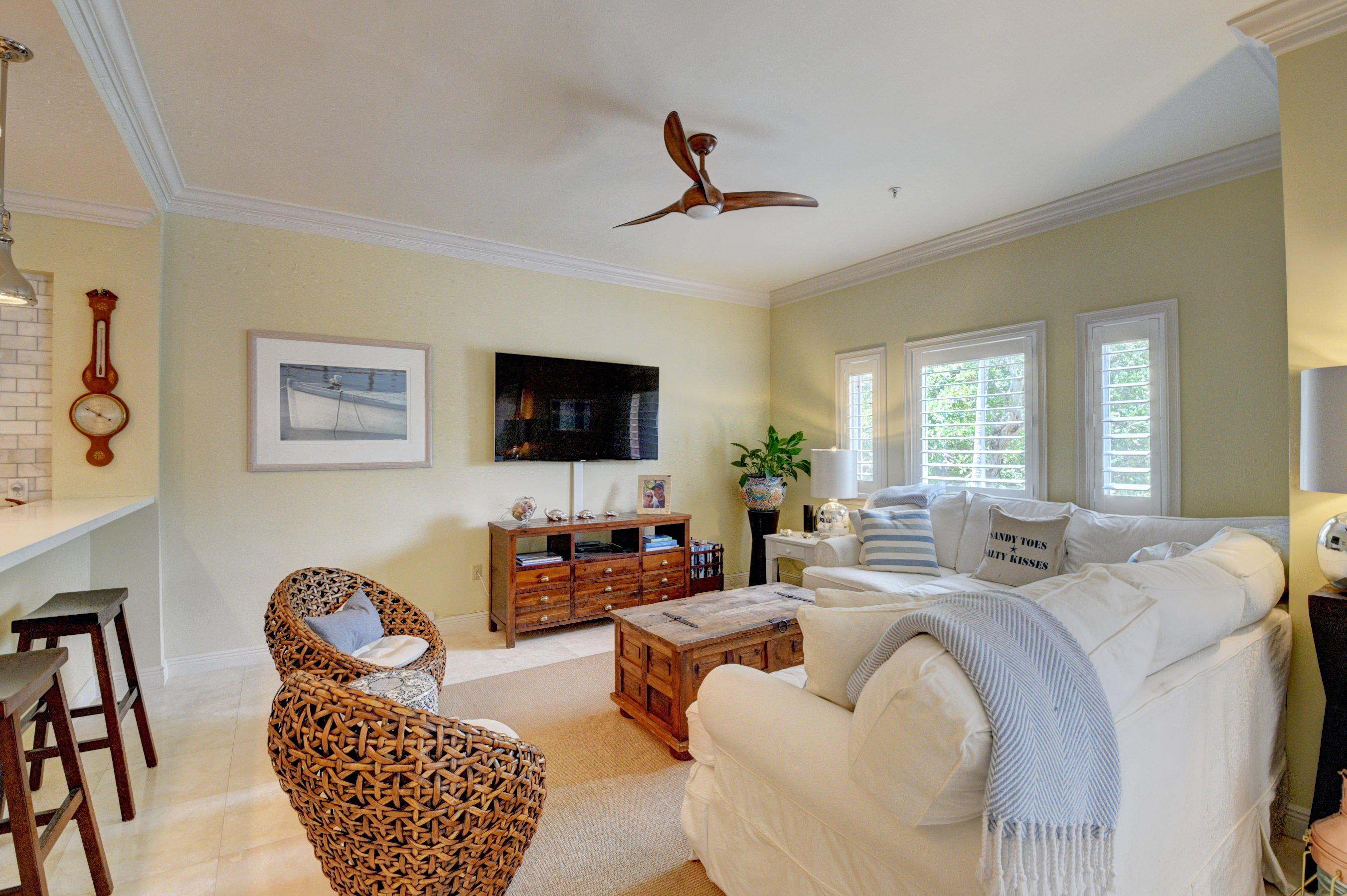 492 East Boca Raton Road Boca Raton, FL 33432 - Photo 14 of 44 a living room with furniture a flat screen tv and a table