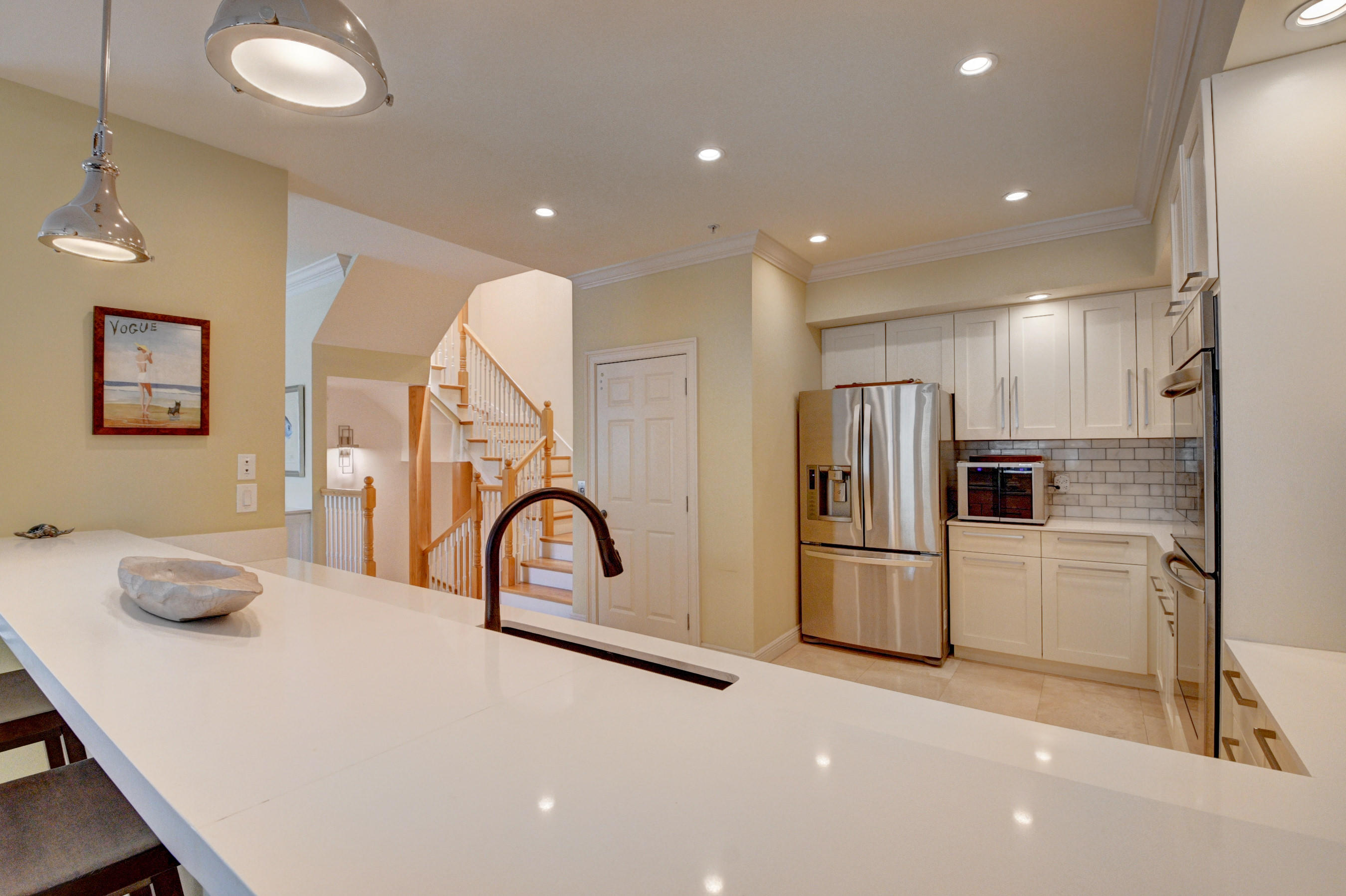 492 East Boca Raton Road Boca Raton, FL 33432 - Photo 16 of 44 a kitchen with stainless steel appliances granite countertop a refrigerator and a stove top oven with wooden floor