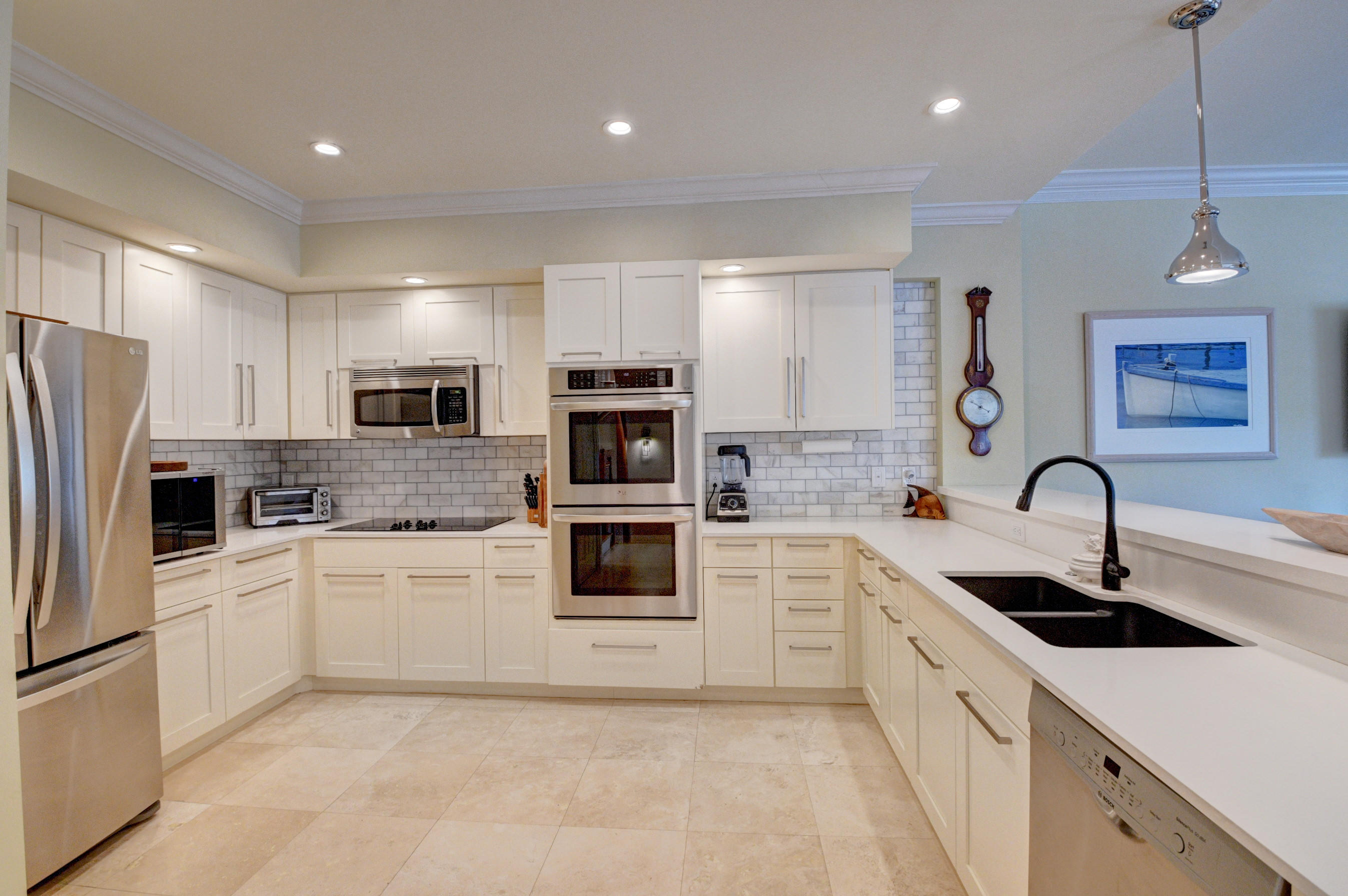 492 East Boca Raton Road Boca Raton, FL 33432 - Photo 18 of 44 a kitchen with white cabinets and white appliances
