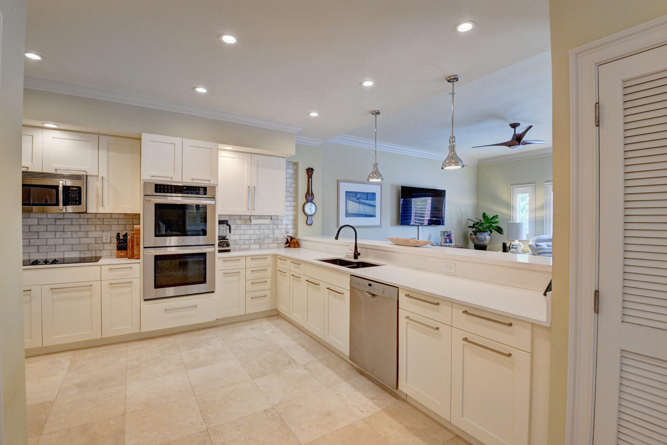 492 East Boca Raton Road Boca Raton, FL 33432 - Photo 21 of 44 a kitchen with white cabinets and stainless steel appliances