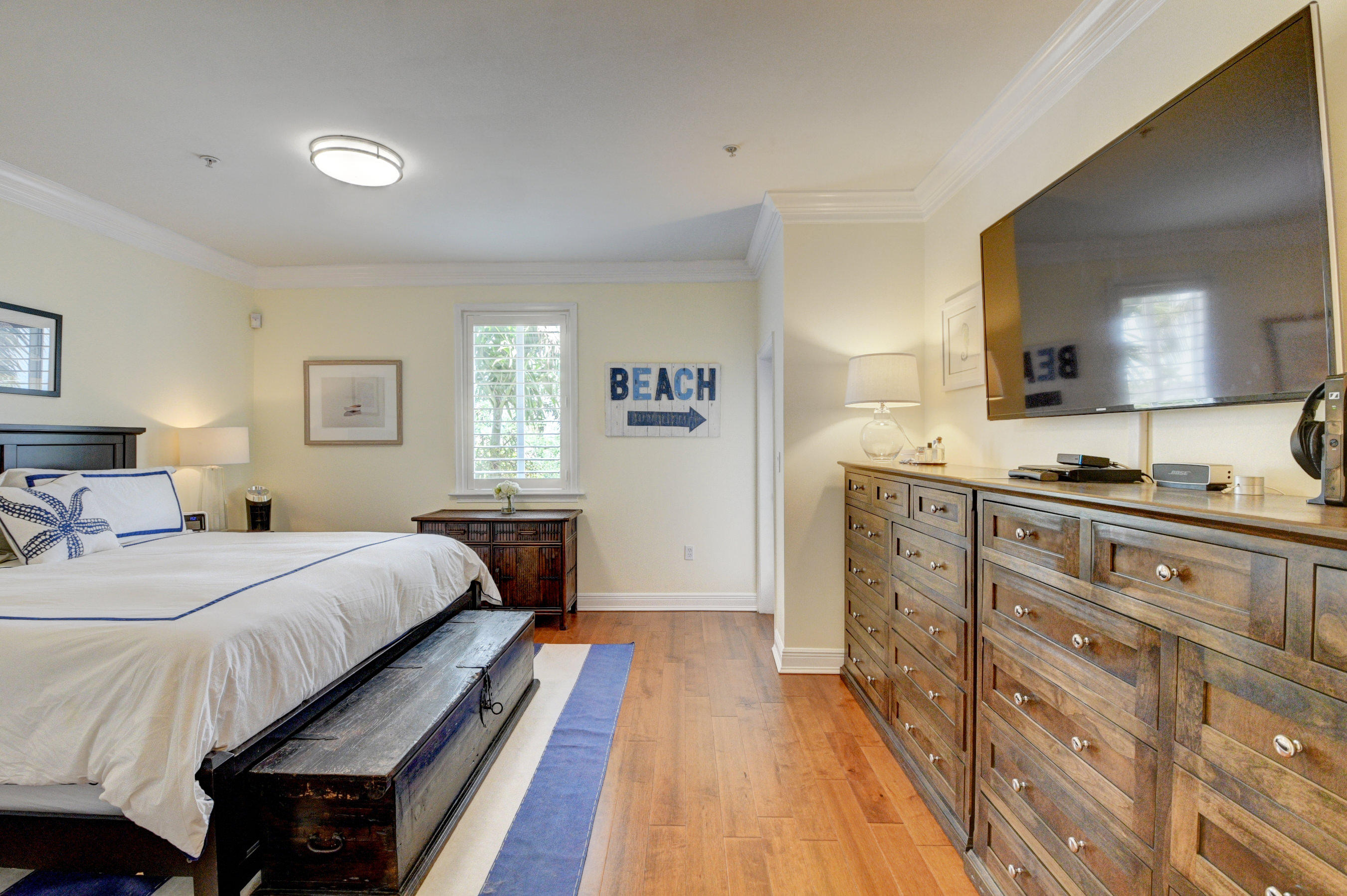 492 East Boca Raton Road Boca Raton, FL 33432 - Photo 24 of 44 a bedroom with a bed and wooden floor