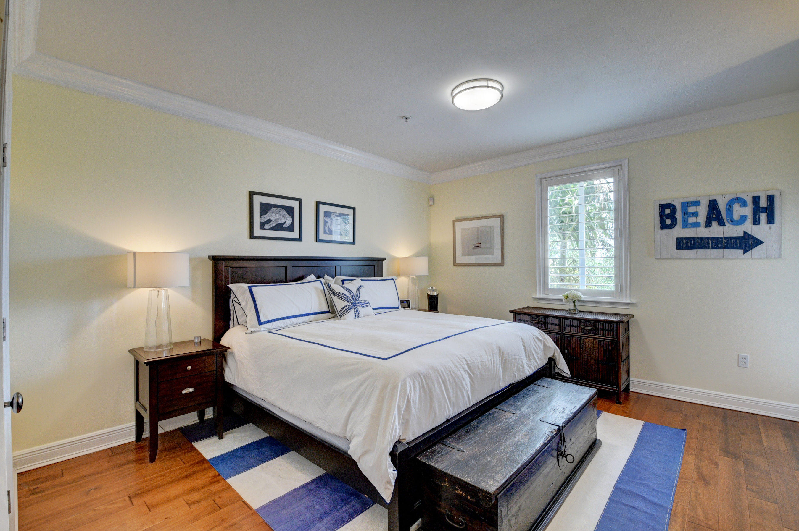 492 East Boca Raton Road Boca Raton, FL 33432 - Photo 25 of 44 a bedroom with a bed and wooden floor