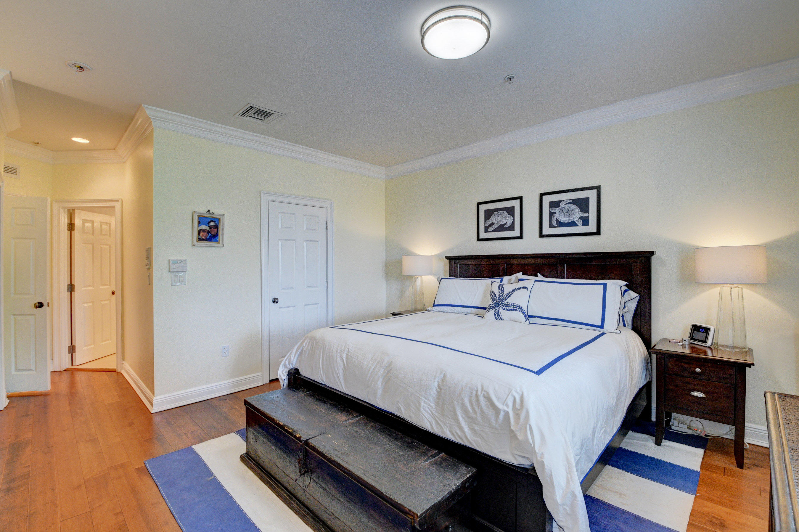 492 East Boca Raton Road Boca Raton, FL 33432 - Photo 26 of 44 a bedroom with a bed and wooden floor