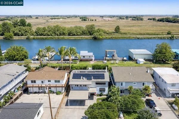 an aerial view of houses with outdoor space and lake view
