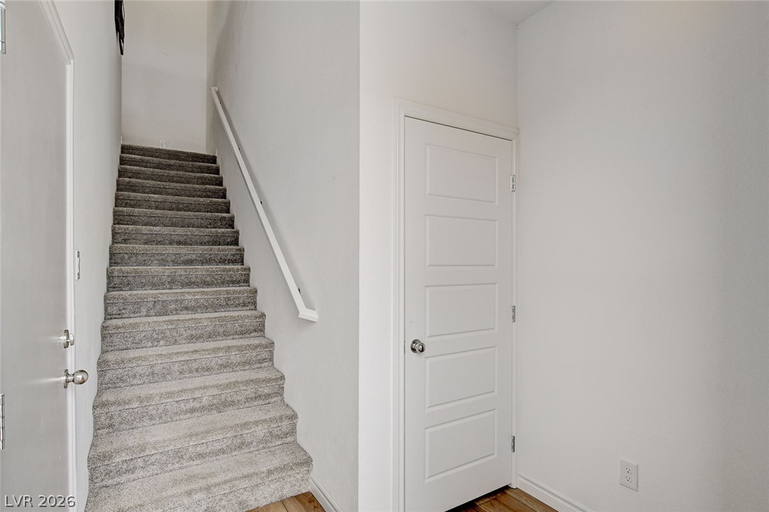 7330 North Decatur Boulevard, Unit 6 North Las Vegas, NV 89084 - Photo 15 of 42 A well-lit interior staircase provides access to upper levels, offering both functionality and a clean aesthetic.