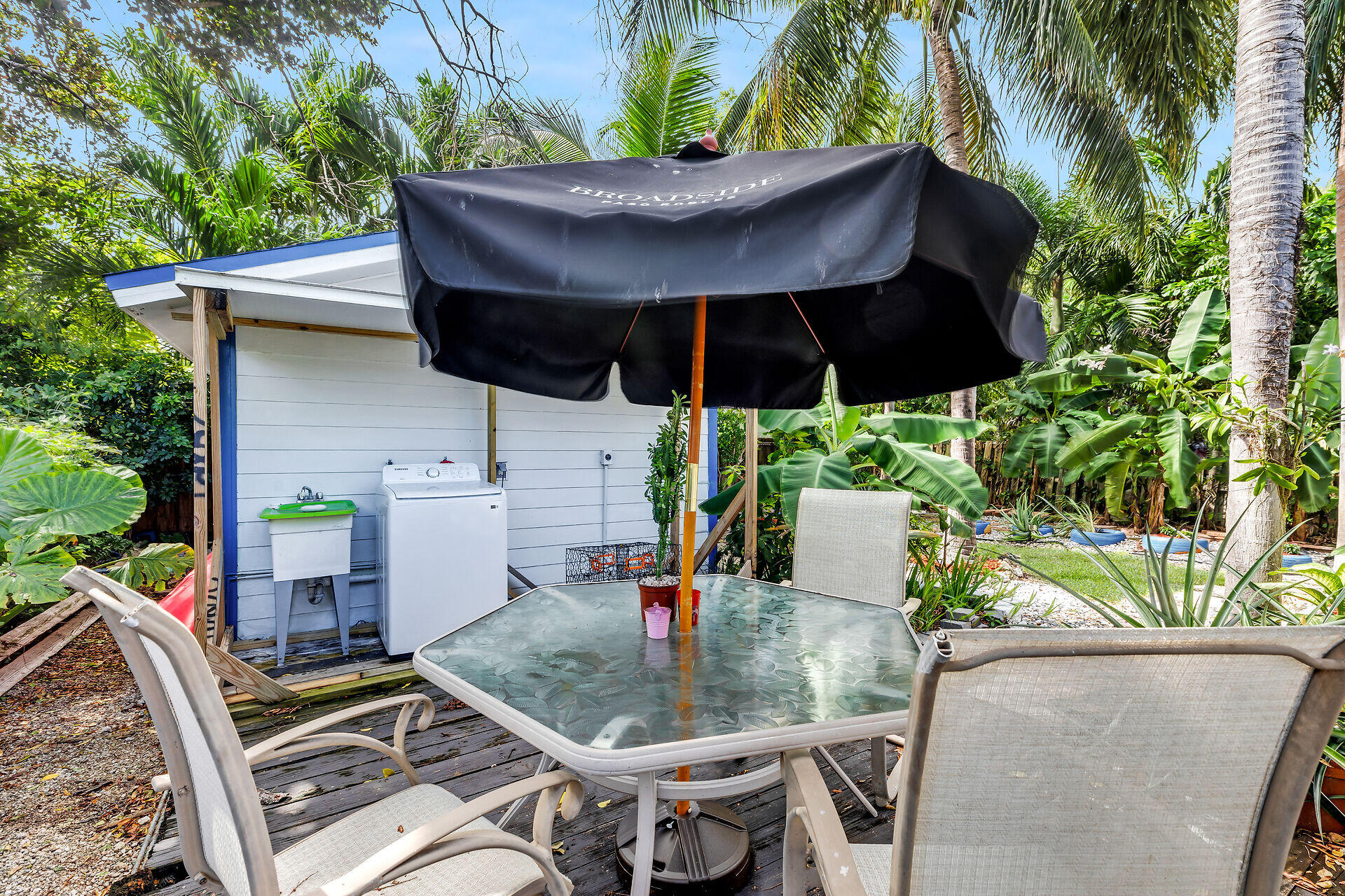 13 Bass Avenue Key Largo, FL 33037 - Photo 35 of 43 a view of table and chairs under an umbrella
