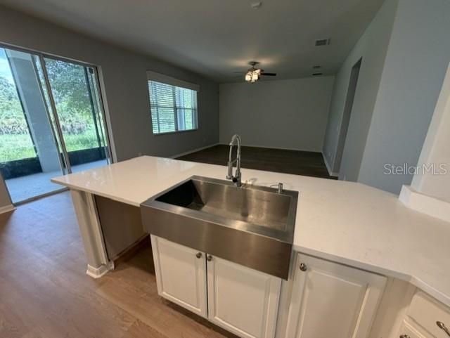 1885 Scrub Jay Road Apopka, FL 32703 - Photo 7 of 29 a kitchen with a table chairs and a refrigerator