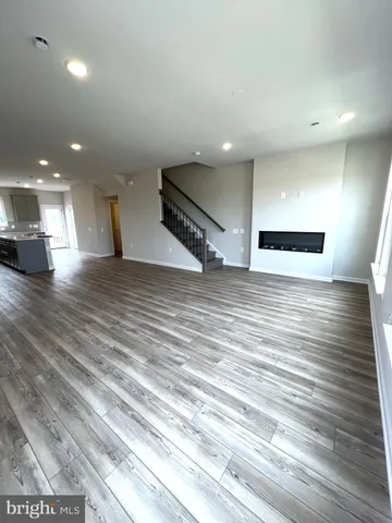 a view of a room with wooden floor