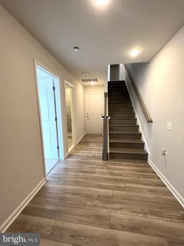 a view of entryway and hall with wooden floor