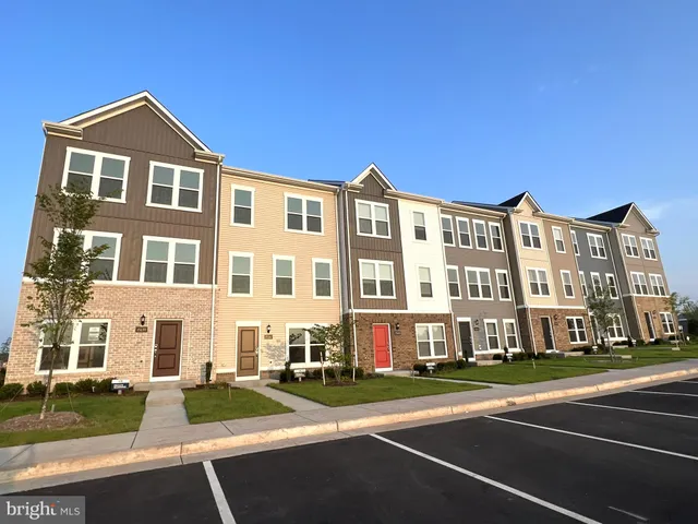 a front view of a residential apartment building with a yard