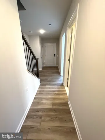 a view of entryway and hall with wooden floor