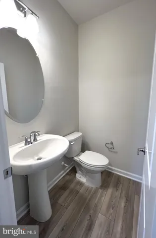 a bathroom with a sink toilet and a mirror