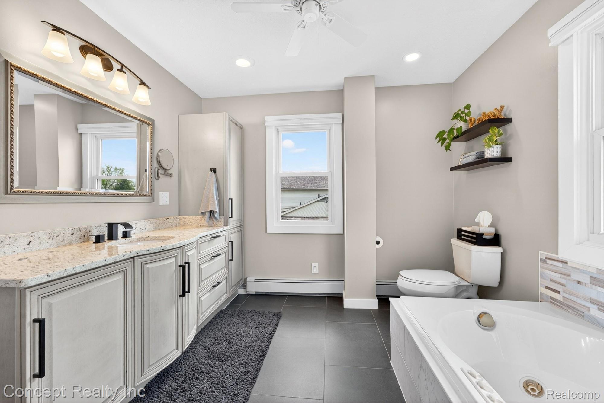 4720 Long Road Newport, MI 48166 - Photo 25 of 46 Full bath featuring vanity, ceiling fan, a tub with jets, baseboard heating, and recessed lighting