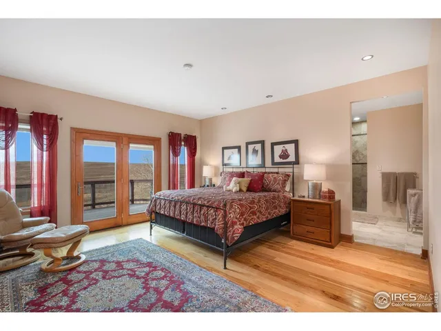 a living room with a bed furniture and a large window
