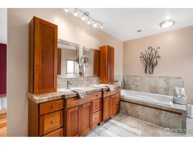 a bathroom with a tub sink and mirror
