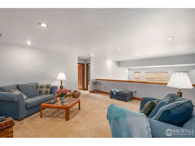 a spacious bedroom with a bed and a dresser