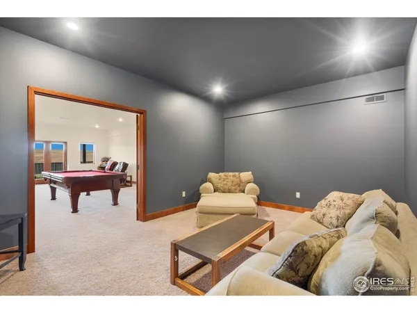 a living room with a bed furniture and next to a window