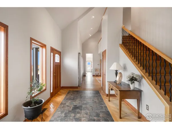 a view of entryway and hall with wooden floor