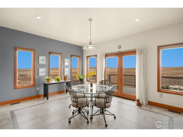 a dining room with furniture and a window