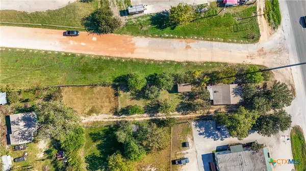 an aerial view of residential houses with outdoor space and lake view