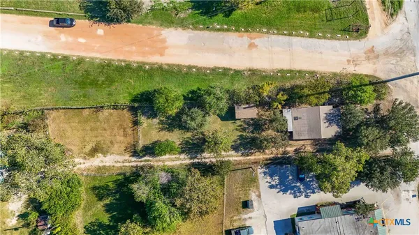 an aerial view of residential houses with outdoor space and street view