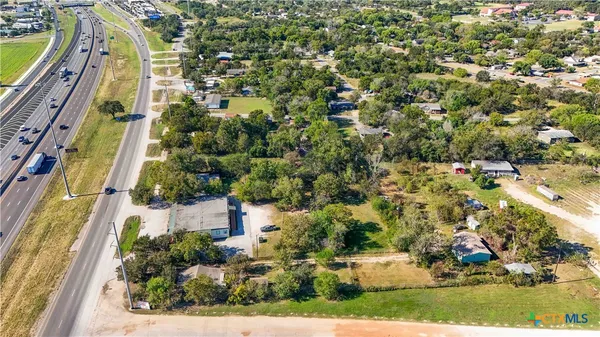 an aerial view of a residential houses with yard