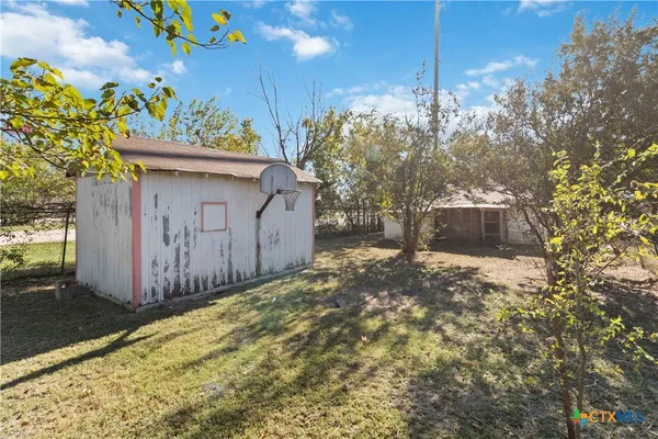 a view of a garage with a tree