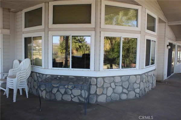 a living room with a large window and furniture
