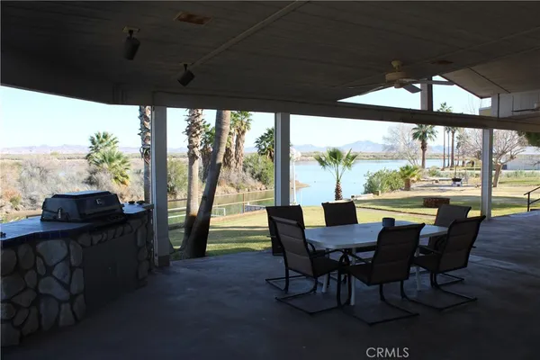 a view of a dining room with furniture large windows and wooden floor