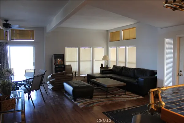 a living room with furniture wooden floor and a flat screen tv