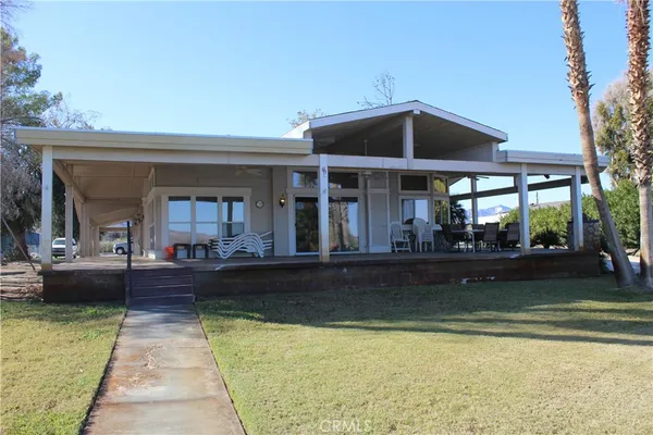 a view of a living room and swimming pool
