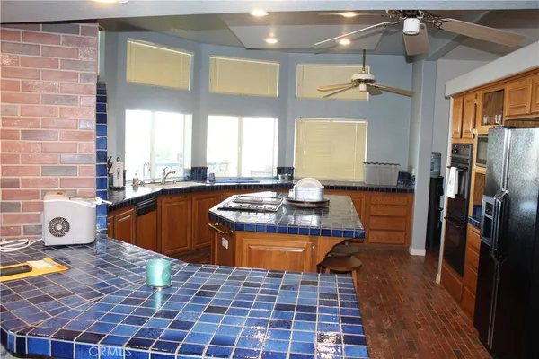 a view of a kitchen with a sink and a refrigerator