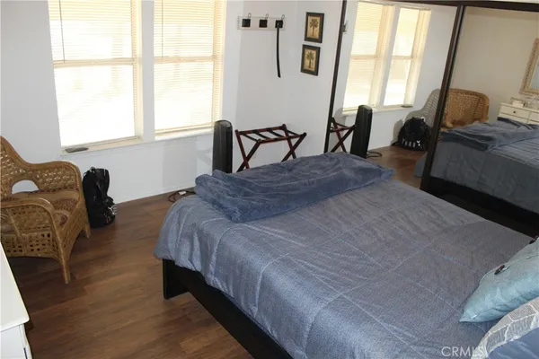 a bedroom with bed chair and window