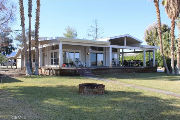 a view of a house with swimming pool and sitting area