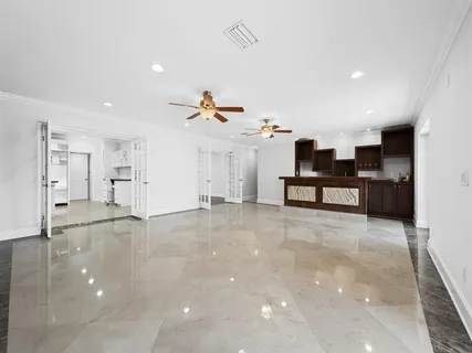 a view of empty room with wooden floor and window
