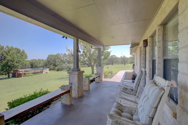 a living room with furniture a flat screen tv and a large window