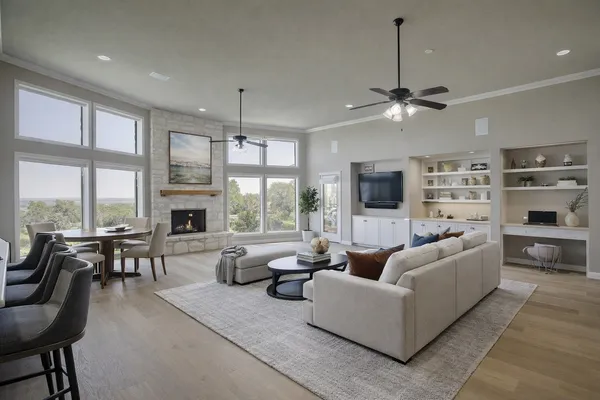 a living room with furniture a fireplace and a large window